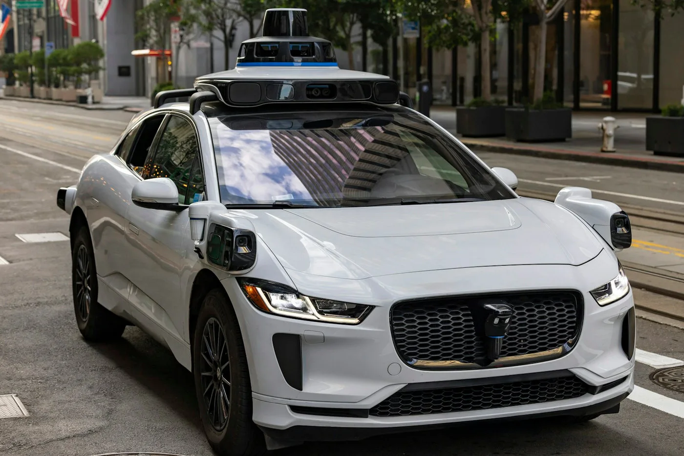 Self-driving vehicle on a city street representing physical validation after simulation