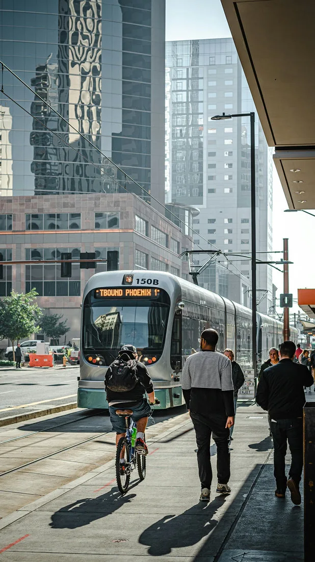 Passengers crossing a platform beside a train during a connected trip