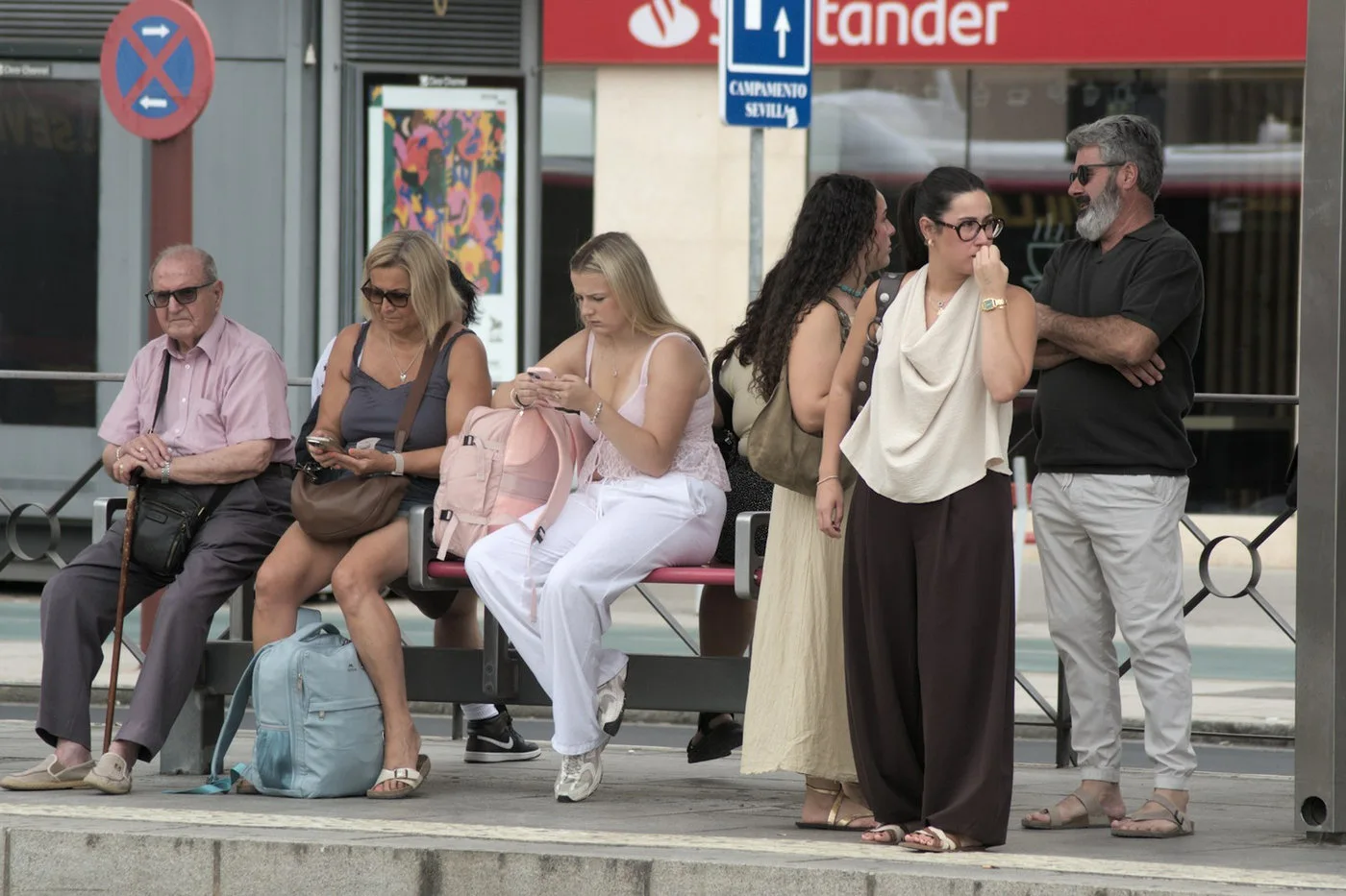 Passengers waiting at a city bus stop