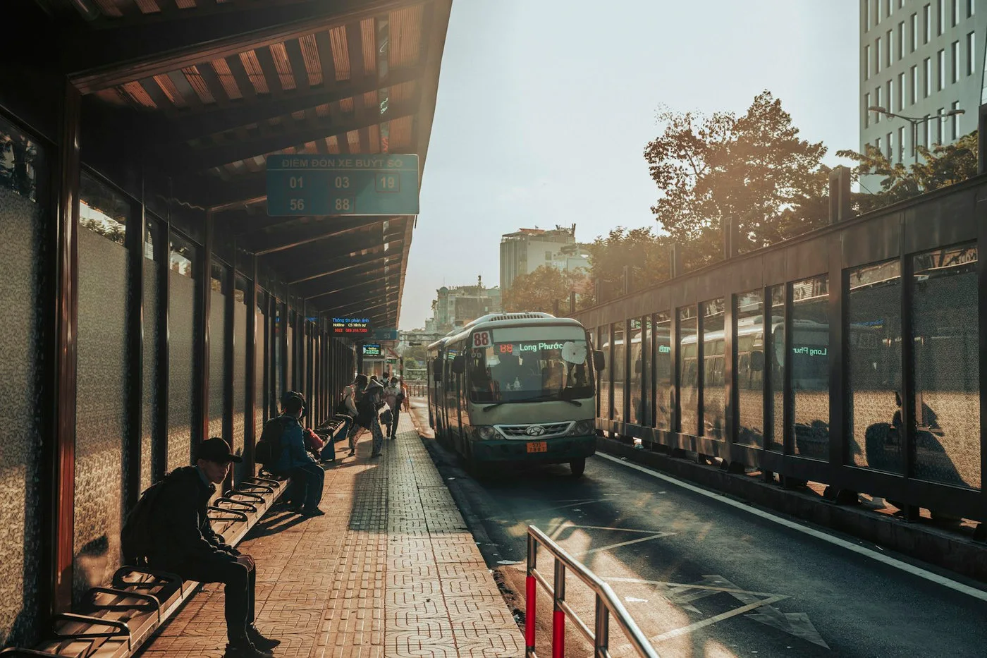 Glass bus shelter with a clear paved waiting area